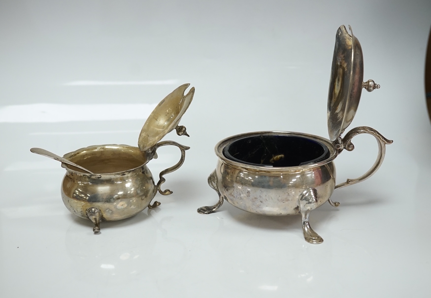 A late Victorian silver mounted horn beaker, Mappin & Webb, Sheffield, 1896, 10.6cm, a.f. a similar repousse silver posy vase and two silver mustard pots. Condition - poor to fair